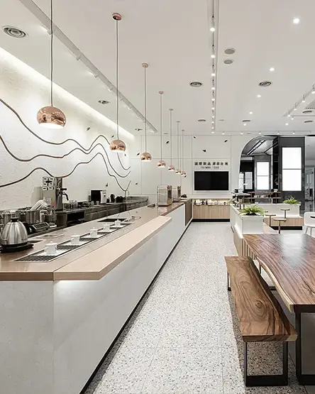 A bright Chi Cha San Chen store interior with pendant lights and a long tea bar