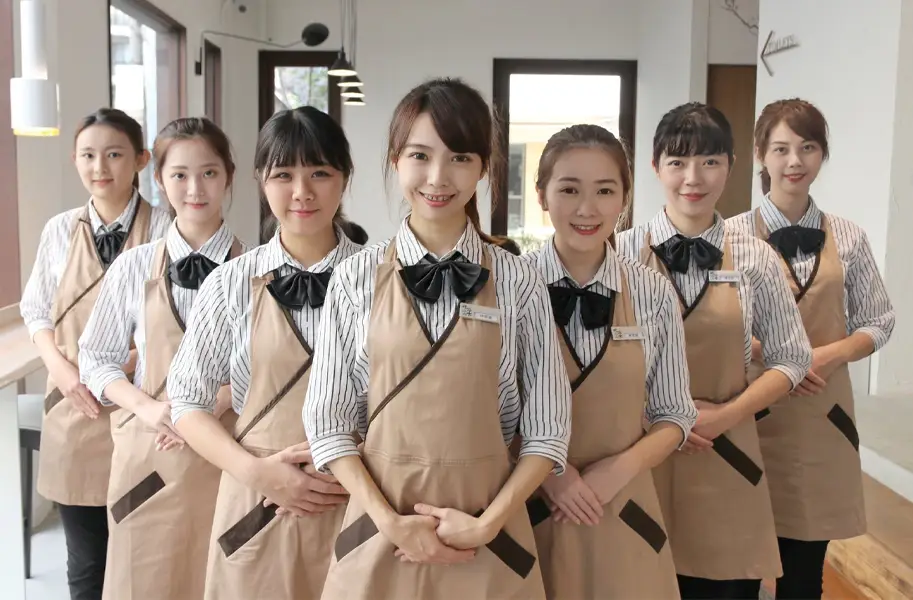The Chi Cha San Chen store team lined up in uniform, smiling
